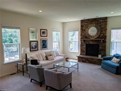 The great room with the stone wall gas fireplace. 