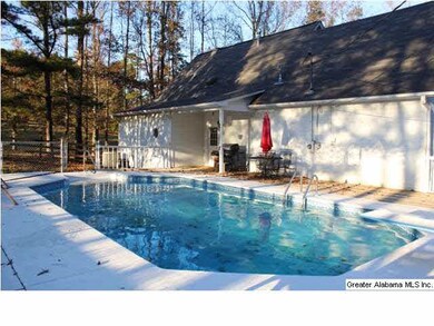 INGROUND POOL IN THE BACKYARD WITH SURROUNDING CHA