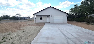View of front of house featuring driveway, stucco siding, and an attached garage