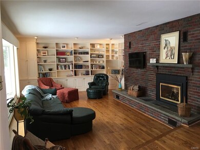 Full view of fireplace wall. Hardwood floors in li