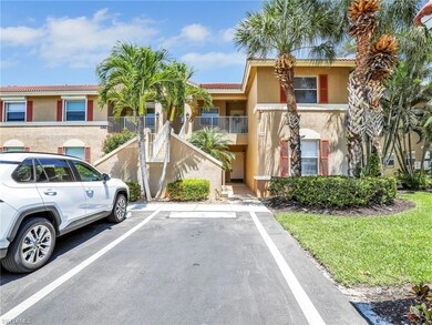 View of front of house featuring stucco siding, uncovered parking, stairs, and a tiled roof