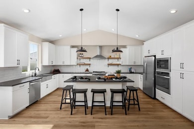 Kitchen with vaulted ceiling and pendant lighting