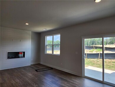 Unfurnished living room with a large fireplace, vi