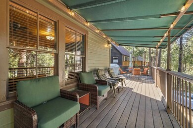 Wooden terrace with an outdoor hangout area and lake views