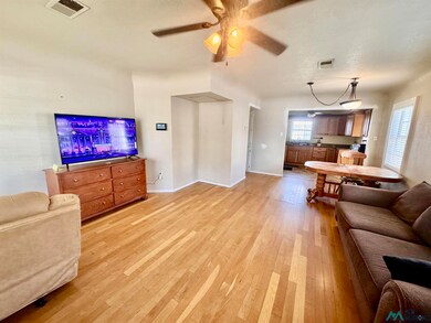 Living area featuring light wood-type flooring and ceiling fan