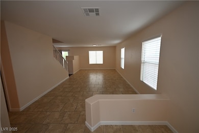 Unfurnished room featuring baseboards and stairway