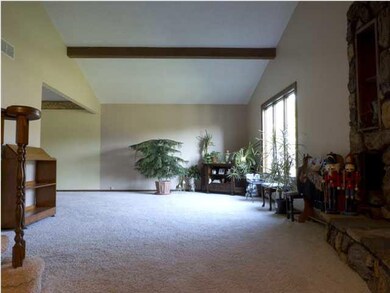 family room with a wood burning fireplace