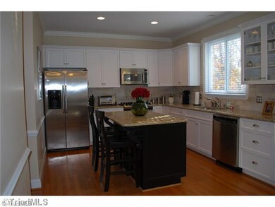 Kitchen. Remodeled kitchen with granite, new cabinets, large island, stainless appliances and wood floors.