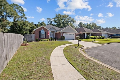 Single story home with driveway, brick siding, and a garage
