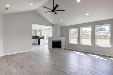 Unfurnished living room featuring ceiling fan, a 