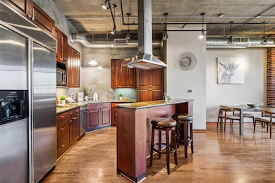Bar seating at island and large refrigerator that
