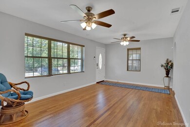 Living roomfeaturing hardwood / wood-style floors,