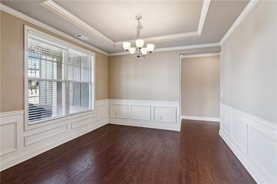 Empty room featuring visible vents, dark wood-styl