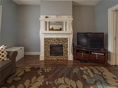 A fireplace is featured in the family room with cu