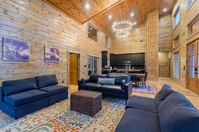 Living room featuring a notable chandelier, light 