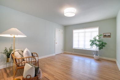 Living area with light wood-style flooring and ba