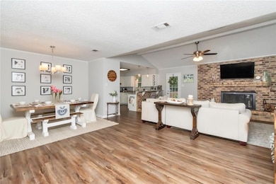Living room with a fireplace, ceiling fan with not