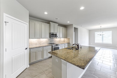 Stunning gourmet kitchen with deep under-mount stainless sink.  Large walk-in pantry for all your needs.