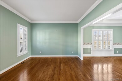 Formal living room off of the foyer w/ crown moldi