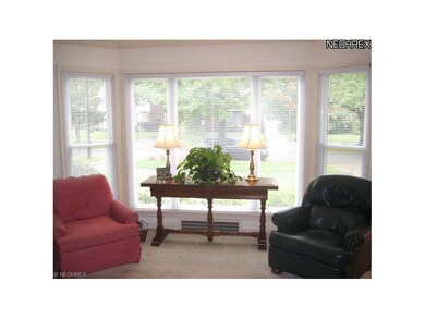 Sunny formal Living Room features bay window, deta