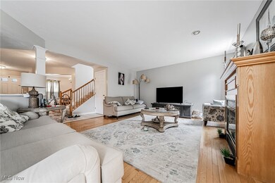 Living area featuring hardwood / wood-style floors, a fireplace, and stairs