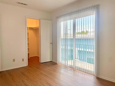 Unfurnished bedroom with a walk in closet, visibl