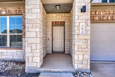 Entrance to property with a garage and stone sidi