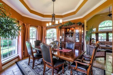 The formal octagonal dining room with trey ceiling adds an elegant touch to this Tuscan style masterpiece.