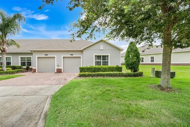 Arrive home to a charming paved driveway bordered by vibrant landscaping and an attached one-car garage.