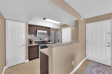 Kitchen with stainless steel appliances, light til