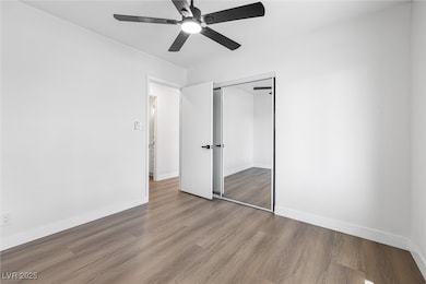 Unfurnished bedroom with wood finished floors, a c