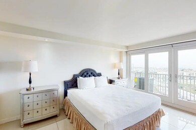 Bedroom with light tile flooring, multiple windows, and access to exterior