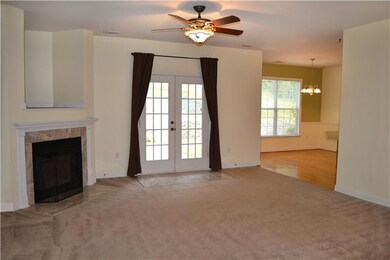 The Living Room also has double French doors with full view glass that open to the covered back porch & patio allowing open views to the pretty backyard. It is also open to the Kitchen, Front Entry, and Formal Dining Room.
