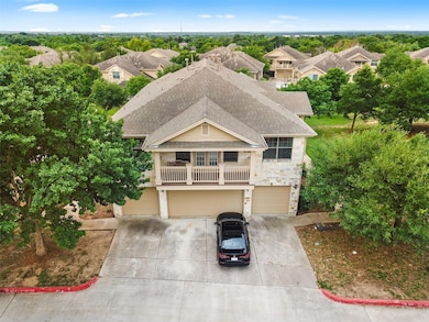 View of front of home featuring a balcony, roof w