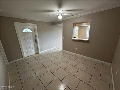 Entryway featuring ornamental molding, ceiling fan