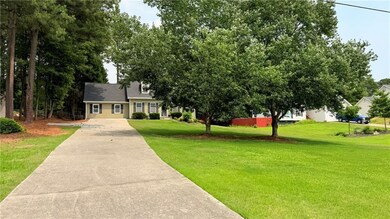 View of front of home featuring concrete driveway and a front yard