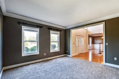 A formal living room offers dentil crown molding, 