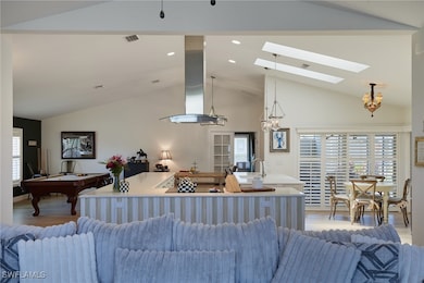 Living room featuring a chandelier, light wood-sty