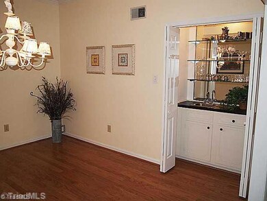 Dining Room. As an added feature, the wet bar with sink, glass shelving, storage cabinets and bifold doors, makes entertaining easy!