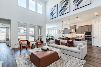 Living room featuring dark wood-style floors, a t