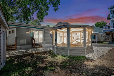 Back of property at dusk with entry steps and a patio