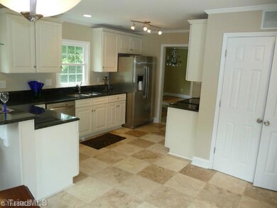 Kitchen. Spacious kitchen with tract and recessed lighting. The doors to the right are the laundry room.