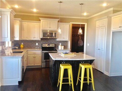 Fresh white cabinets with granite island dark stai