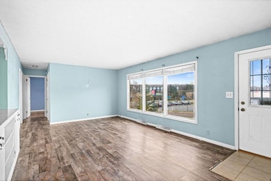 Unfurnished living room featuring wood finished floors