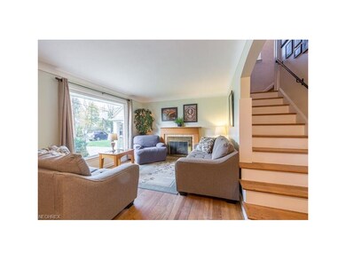 Living room with bright picture window and hardwoo