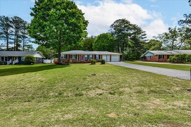 Single story home featuring driveway and a front l