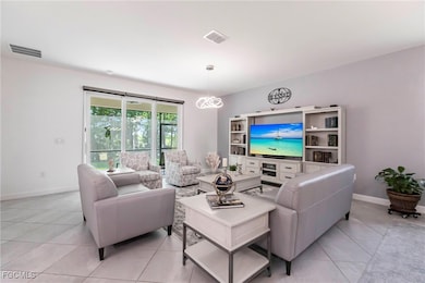 Living room featuring baseboards and light tile patterned floors
