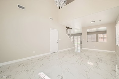 Unfurnished living room with a chandelier, baseboa