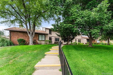 Perched on a hill with green space out front