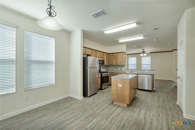 Kitchen with island is open to the living area and has dining area